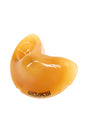 Angled view of glossy yellow fortune cookie–shaped glass pipe with HEMPER logo, compact dry herb hand piece