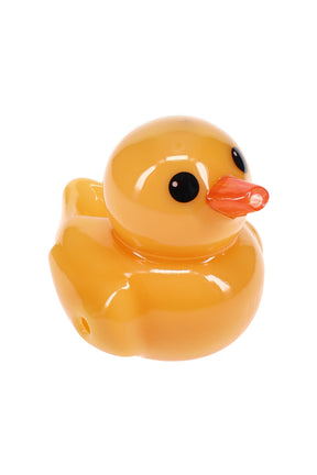 Angled view of yellow ducky-shaped glass hand pipe showing sculpted duck face and smooth glossy finish for dry herb