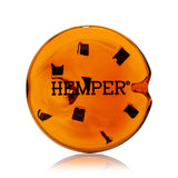 Top view of amber cookie glass hand pipe showing HEMPER logo and dark chip insets across the cookie surface
