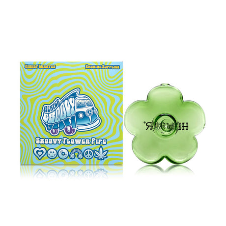 Retail-ready Hemper packaging next to green flower glass hand pipe, compact novelty shape for display-case styling