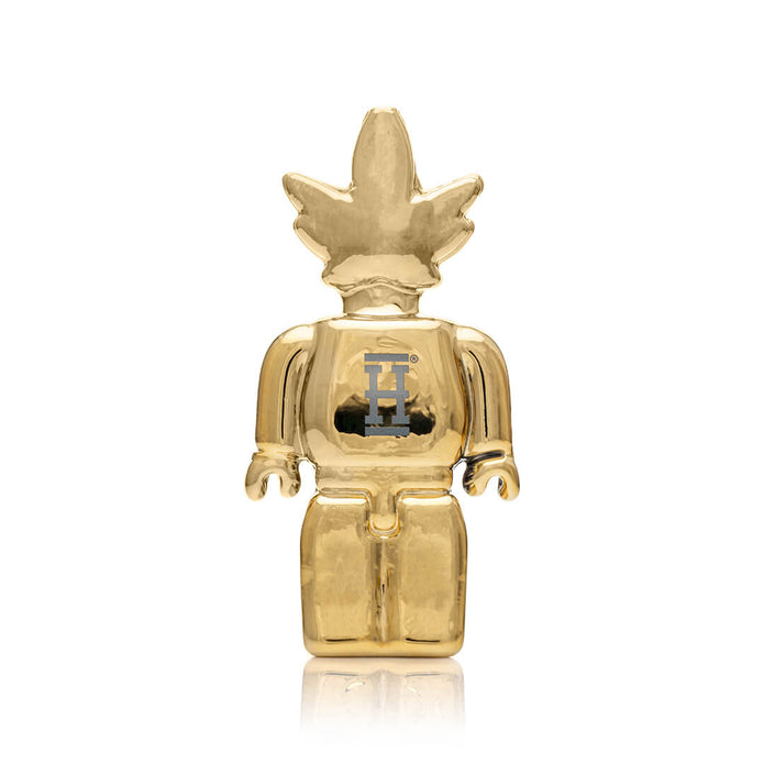 Back view of mirror-gold Weedbrick character glass hand pipe showing “H” logo detail and smooth rounded body shape