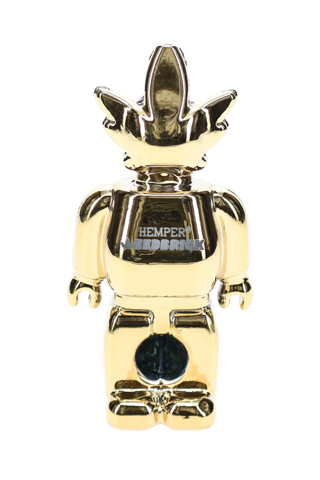 Front view of mirror-gold Weedbrick character glass hand pipe with contrasting dark bowl area and compact profile