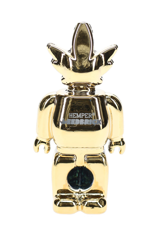 Front view of mirror-gold Weedbrick character glass hand pipe with contrasting dark bowl area and compact profile