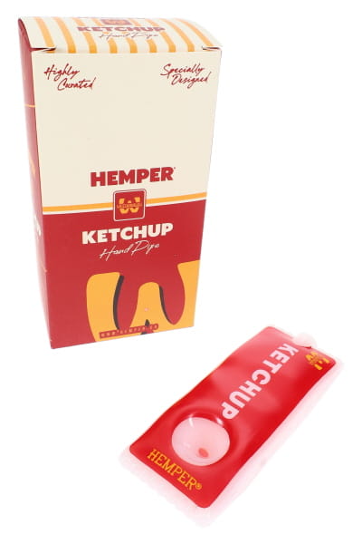 Red 4-inch glass hand pipe shaped like a ketchup packet with Hemper retail box in the background