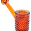 Amber Jane West glass hand pipe with warm orange body, textured bowl, and flat tabletop base