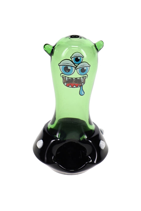 HEMPER Space Monster glass hand pipe with green body, black saucer base, and multi-eye face decal