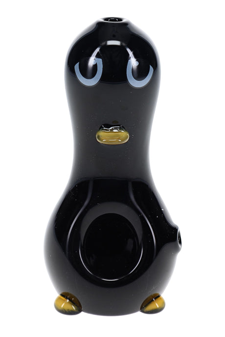 Penguin-shaped glass hand pipe with black body, white belly, yellow beak, and yellow feet