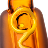 Close-up of BigFun! Glizzy glass hand pipe bowl framed by raised yellow mustard and amber borosilicate glass