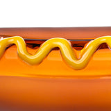 Close-up of BigFun! Glizzy hot dog hand pipe showing the glossy raised yellow mustard swirl over amber glass