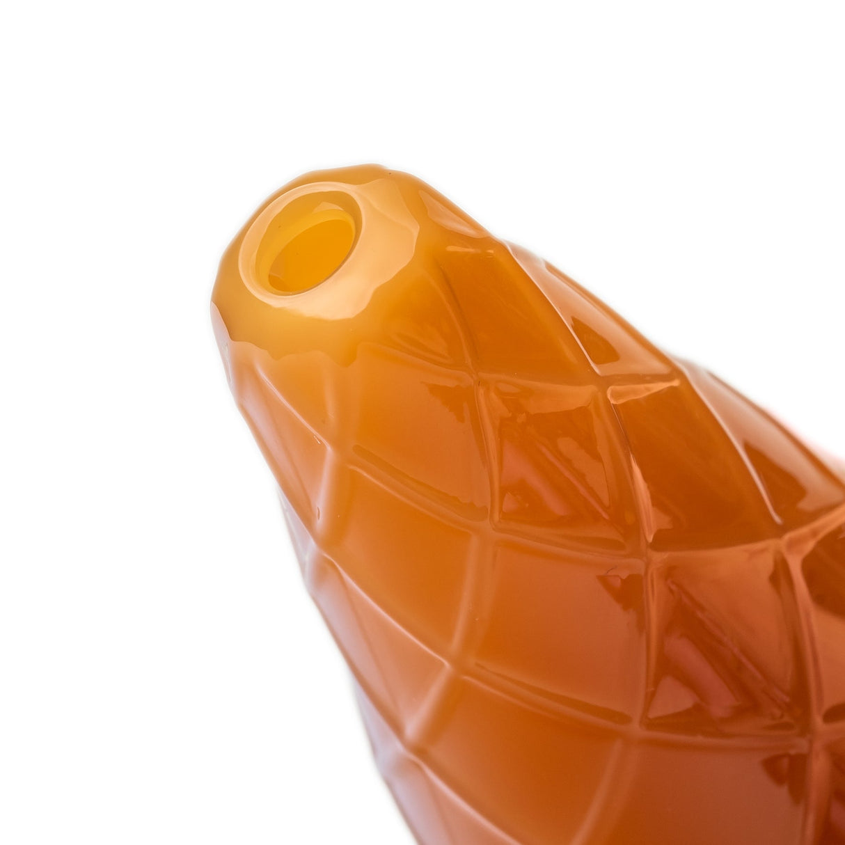 Close-up of orange waffle cone mouthpiece on ice cream glass hand pipe with raised diamond texture
