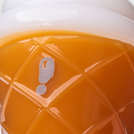 Close-up of logo mark and raised waffle cone texture on orange ice cream glass hand pipe body