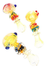 Assorted twisted squiggle spoon pipes with pale yellow glass, colorful ribbons, and raised marbles