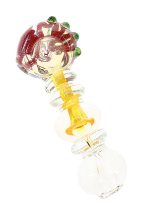 Gold fumed glass spoon pipe with striped bowl, green marbles, ring accents, and 4.5 inch body