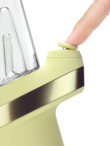 Puffco Peak Zest smart rig close-up with finger pressing the yellow Joystick Cap