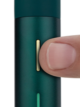 Close view of Puffco Pivot Pine showing the slim gold control button and LED bar for visual timing on the pen body.