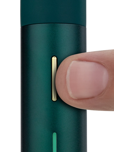 Close view of Puffco Pivot Pine showing the slim gold control button and LED bar for visual timing on the pen body.