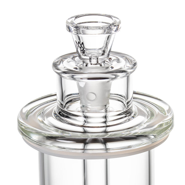 Close-up of piston-style mouthpiece and inner core on clear glass bong, showing removable slide and seal gasket.