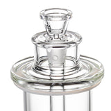 Close-up of piston-style mouthpiece and inner core on clear glass bong, showing removable slide and seal gasket.