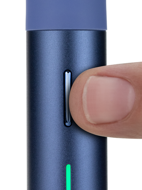 Puffco Pivot Sapphire dab pen close-up with finger pressing the slim control button