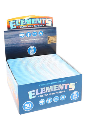 Elements King Size Slim rolling papers 50-count display box, ultra-thin rice paper with vegan gum and watermark, booklet rows in blue ocean-themed tray.