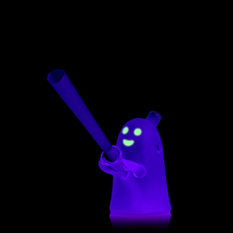 Glowing ghost blunt bubbler in the dark with bright face details, pre-roll inserted in the holder to show water-cooled use.