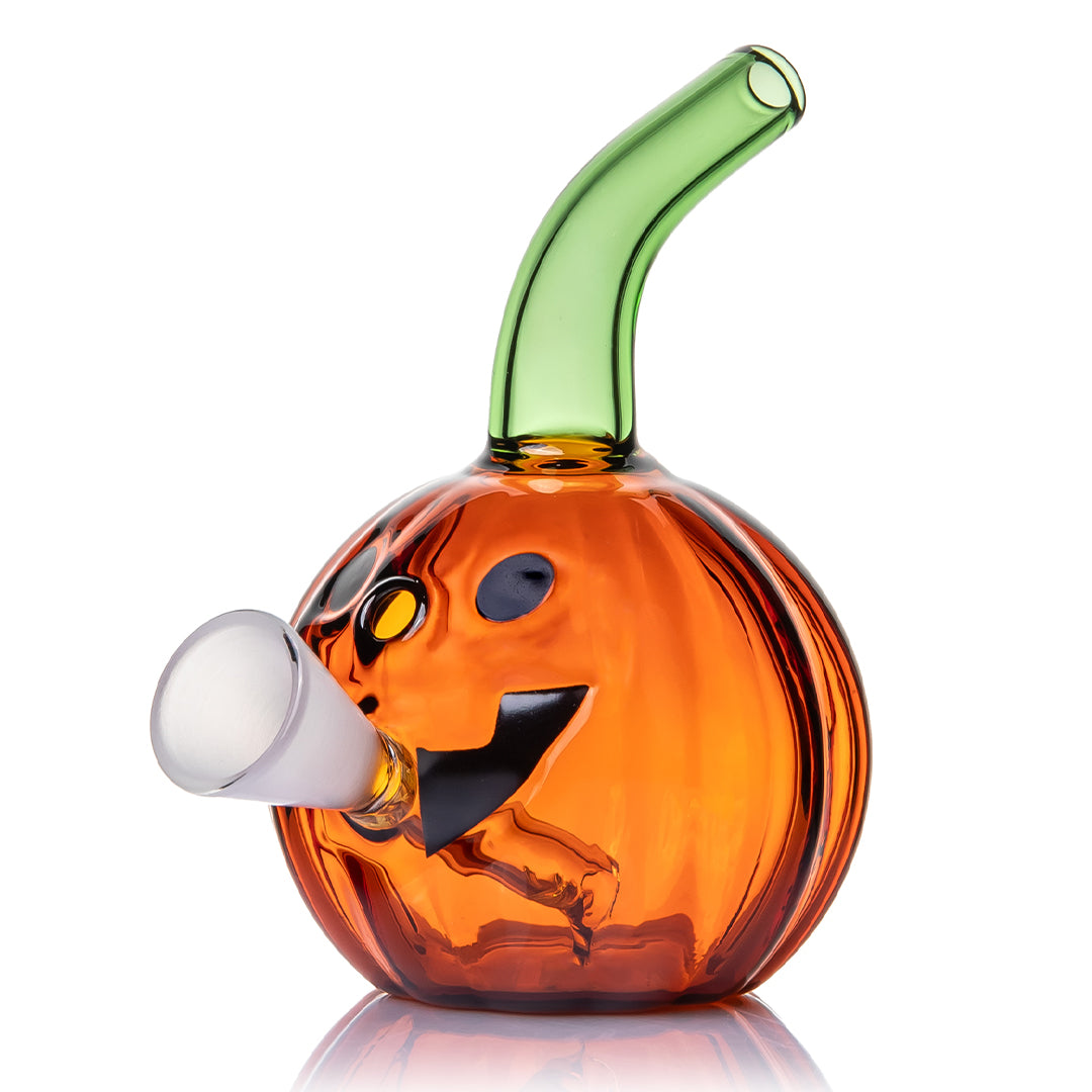 Jack O'Ripper glass bubbler angled front view with orange jack-o'-lantern body and curved green mouthpiece
