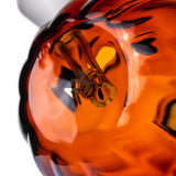 Close-up of Jack O'Ripper glass bubbler internal glass detail visible through the translucent orange pumpkin body