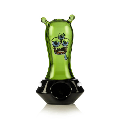 Front view of green space monster hand pipe with black base, white dots, and alien face graphic