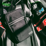 Dr. Dabber travel bag in black with shoulder strap and front zip pocket shown in lifestyle setting