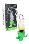 Green Lookah Dinosaur e-rig with clear glass dinosaur body and quartz cup coil, packaged next to product box.