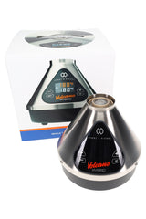 Storz & Bickel Volcano Hybrid desktop vaporizer with retail box, stainless finish, triangular touch display and top opening visible.