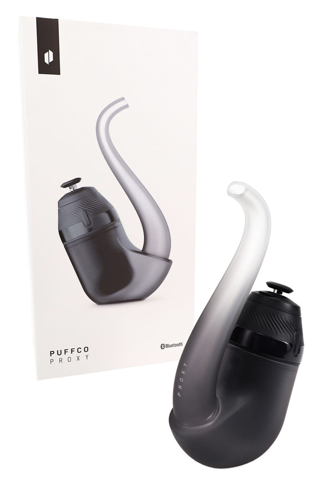 Puffco New Proxy modular vaporizer in Haze beside retail box, curved sherlock glass with joystick cap and app-ready base.