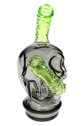Smoky gray skull-shaped MJ Arsenal glass top with neon green ribbed mouthpiece, designed to fit the Puffco Peak e-rig, shown on white.