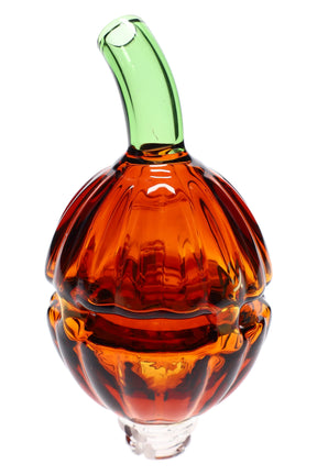 Pumpkin-shaped MJ Arsenal glass top in translucent orange with curved green stem, compatible with the Puffco Pivot e-rig, shown on white.