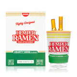 Boxed Hemper ramen Peak top beside glass piece on white background, gift-ready food-themed device upgrade