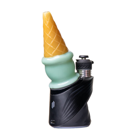 Angled mint ice cream Peak glass top mounted on black device beside exposed chamber