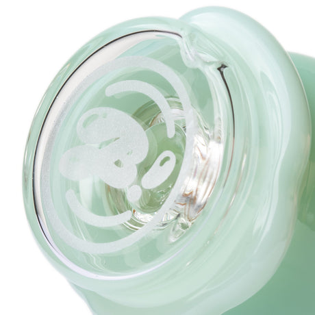 Bottom view of mint Peak glass top showing clear base opening and frosted emblem detail