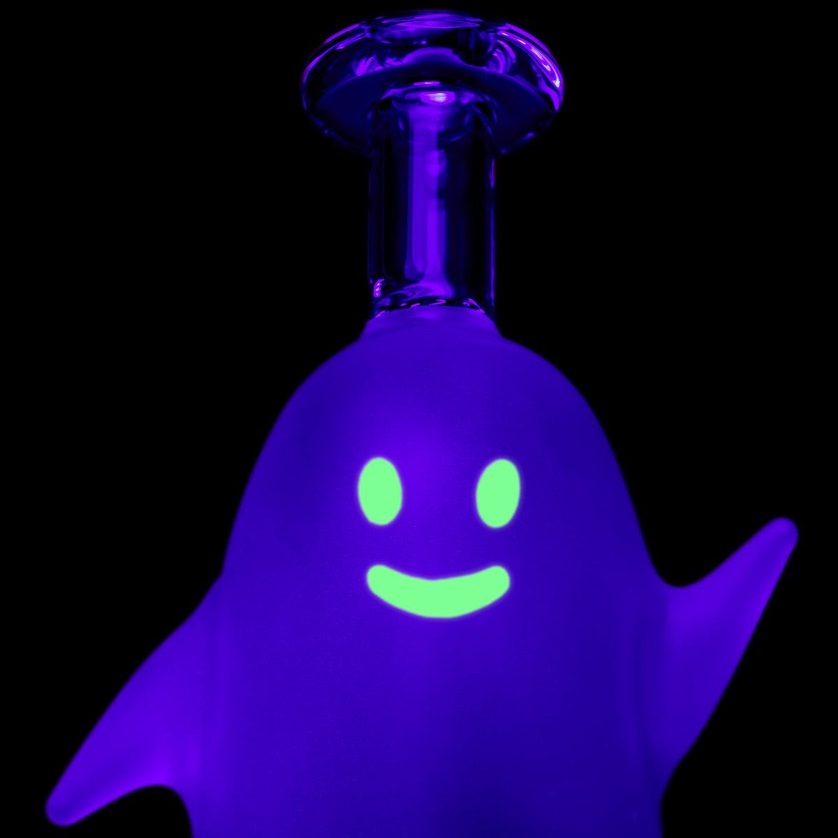MJ Arsenal Specter Peak glass top close-up under UV light with bright green ghost face and purple frosted body
