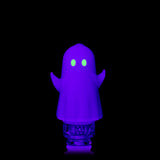 Close-up MJ Arsenal Specter Pivot glass attachment under UV light with glowing green eyes and raised arms