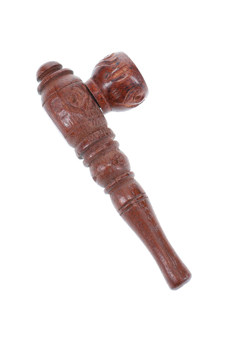 Small carved wood hand pipe with upright bowl and detailed stem engraving, rustic brown smoking pipe on a white background.