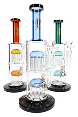 Three 6B Glass double tree perc bongs with blue, amber and teal accents, clear chambers and black bases.