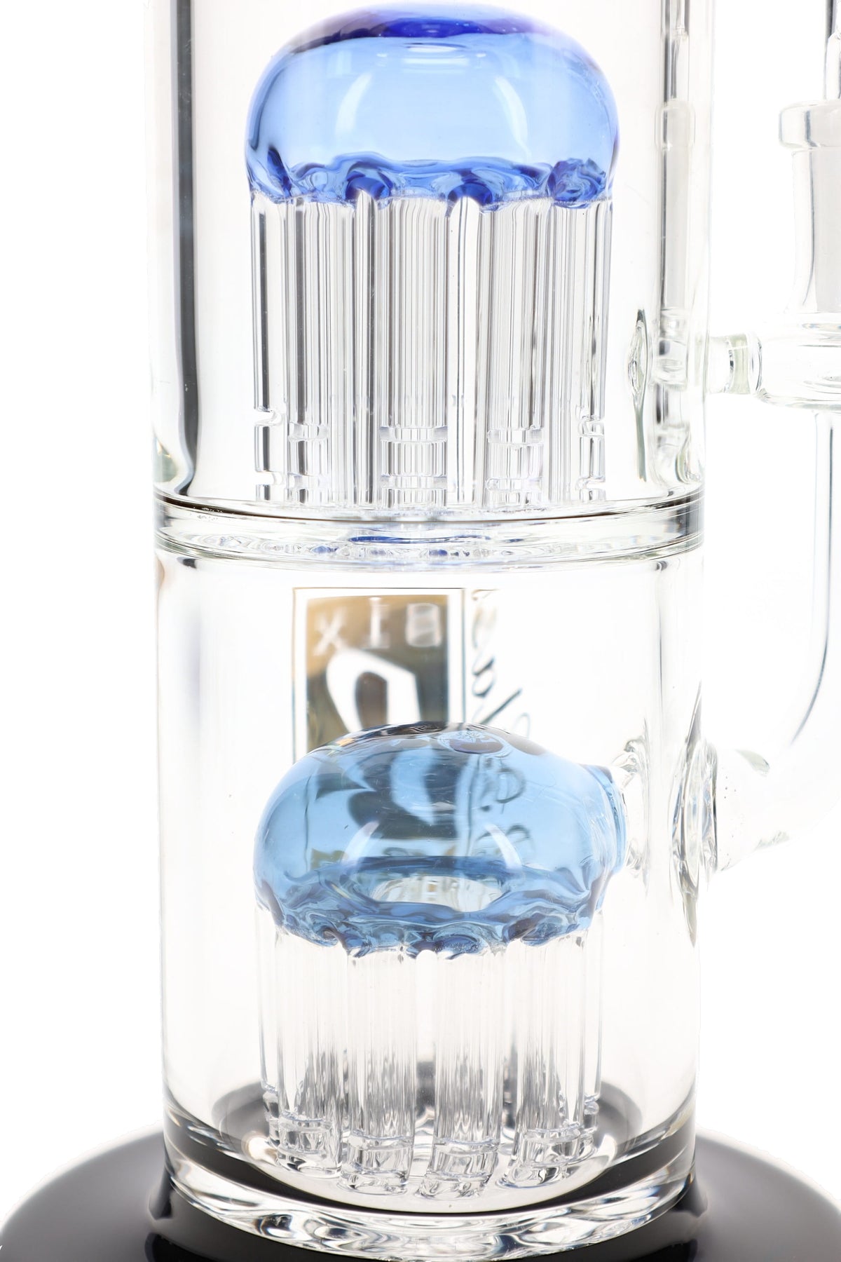 Close-up of two stacked tree percolators with blue dome tops and slotted clear glass arms inside a 6B Glass bong.
