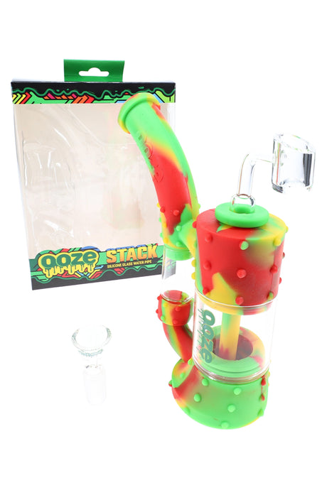 Ooze “Stack” silicone and glass bubbler dab rig in rasta colors with 14 mm quartz banger and herb bowl, dual stacked chambers.