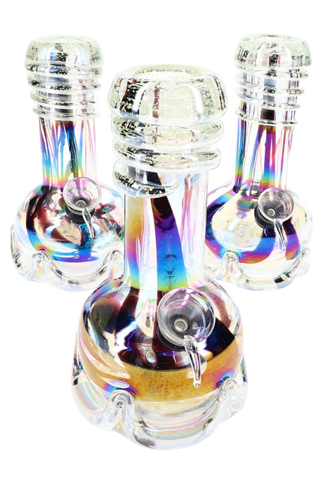Trio of 7-inch beaker bongs glowing bright green frit under black light, highlighting ringed mouthpieces against dark backdrop.
