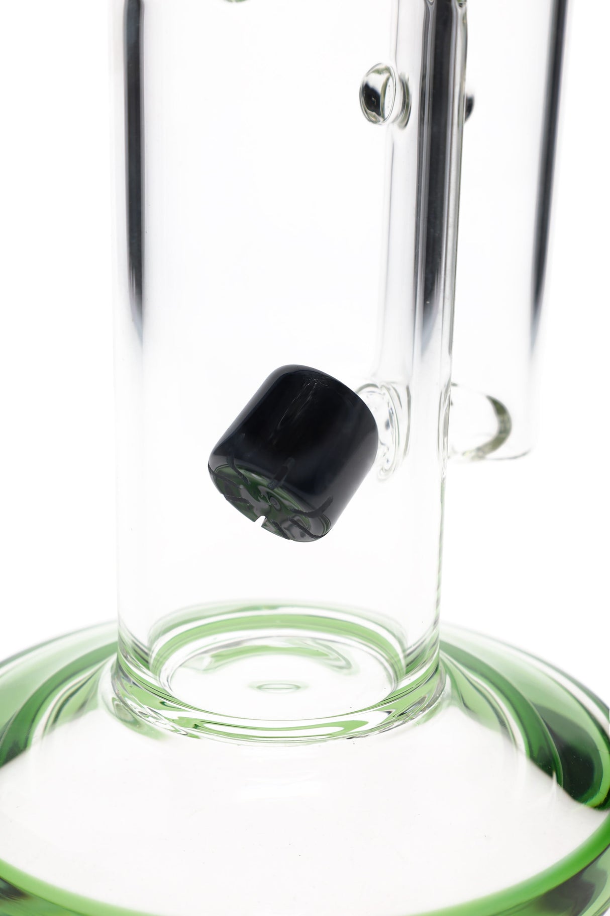 Close-up of the bong’s internal perc diffuser near the base, angled slitted insert inside the straight tube chamber.