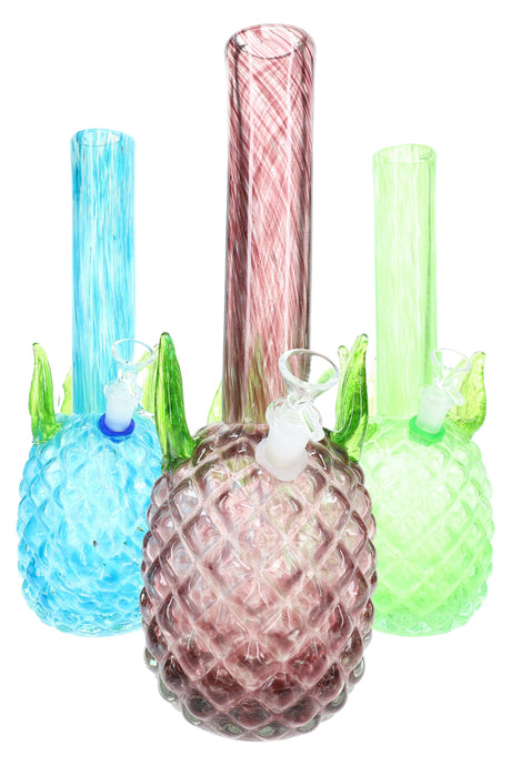Trio of soft glass pineapple bongs in teal, rose, and light green with sculpted leaves and swirled straight necks; colorful assorted designs.