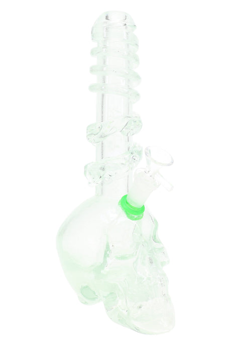 Translucent green soft glass skull water pipe with spiral rings and skull-shaped base; photographed with a grommeted slide installed.