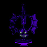 Nocturne rig glowing in the dark with illuminated face accents, bat-wing silhouette visible under blacklight.