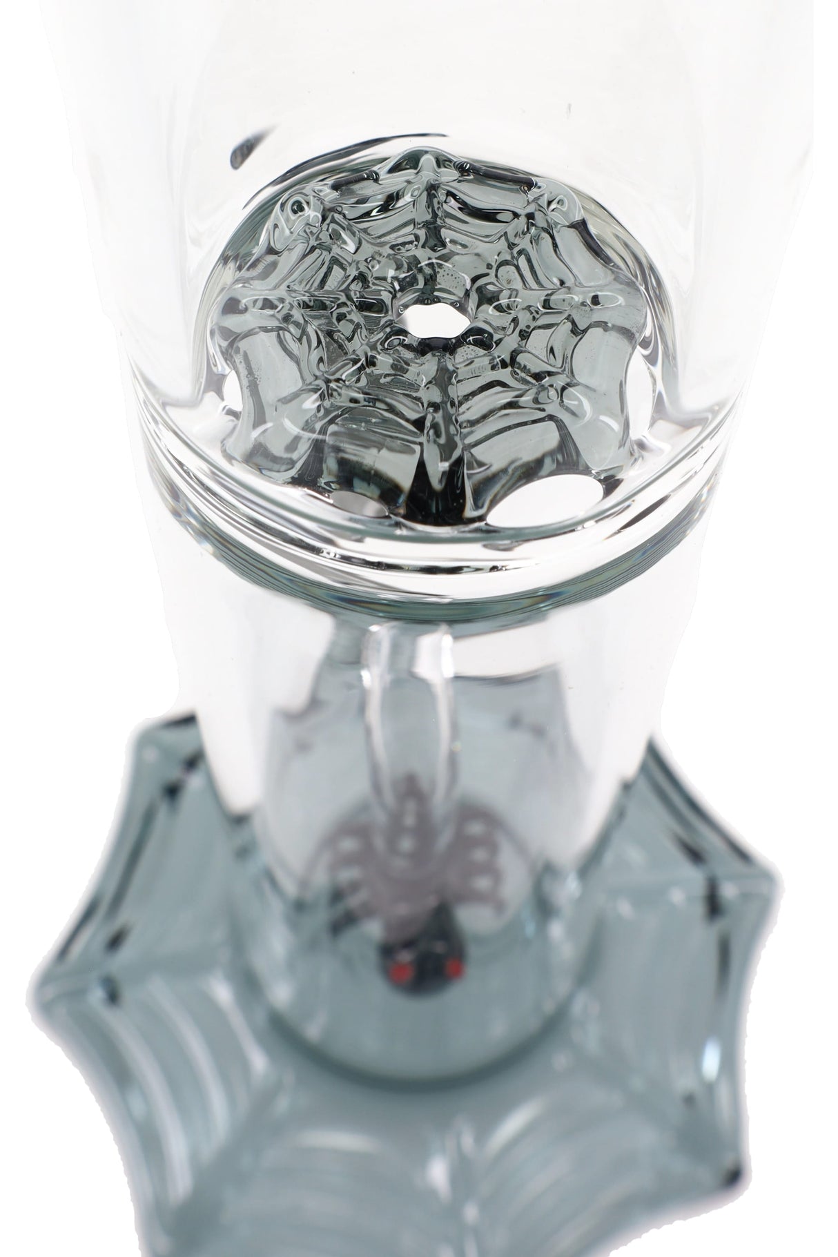 Interior base detail of the glass bong highlighting the molded spider-web disc percolation pattern above the webbed foot.