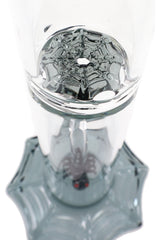 Interior base detail of the glass bong highlighting the molded spider-web disc percolation pattern above the webbed foot.